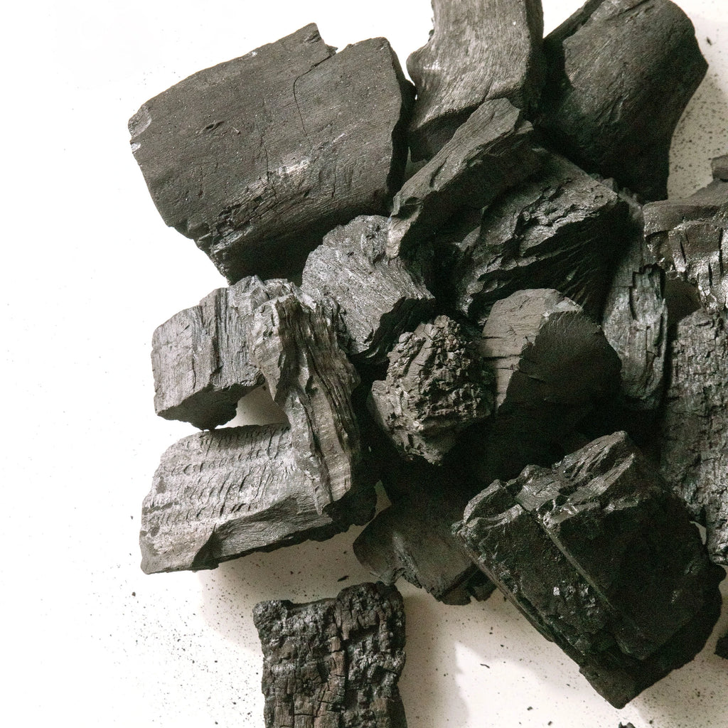 A small pile of Char-Griller Lump Charcoal, showing variations in lump size and shape