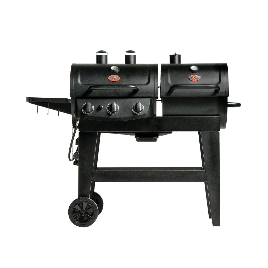 Dual Fuel Pro 3-burner gas and charcoal grill and smoker. Grill has 2 bodies, gas on the left and charcoal on the right. Grill is on a cart with 2 wheels. The gas hose/valve connector is on the left side of the grill, below a side shelf that has 3 utensil hooks.