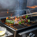 Skewers of chunks of sausage, shrimp, green bell peppers, and red onions